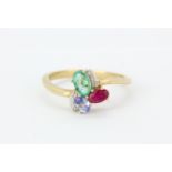 A 9ct yellow gold ring set with an oval cut emerald, ruby, sapphire and diamonds, (P.5).