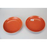 A pair of Chinese orange red glazed porcelain dishes, Dia. 22.5cm.