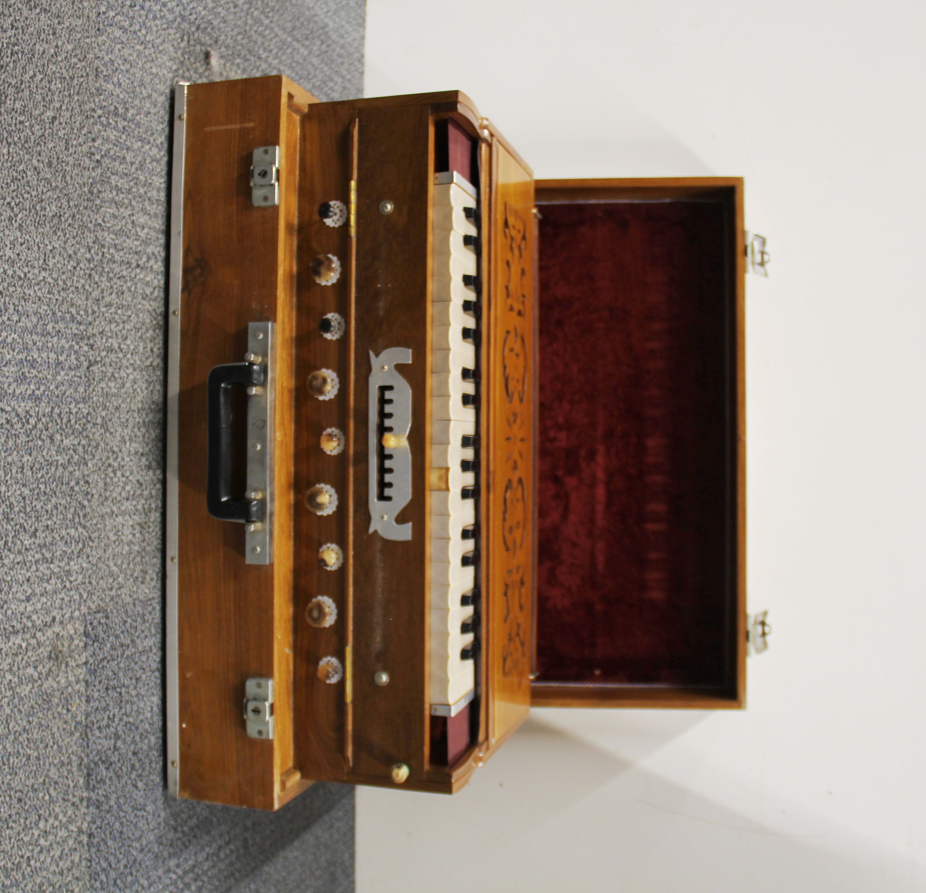 A beautiful cased hand pumped wooden keyboard.