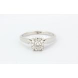 An 18ct white gold (stamped 18ct) diamond set cluster ring, (O.5).