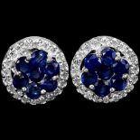 A pair of 925 silver cluster earrings set with sapphires and white stones.