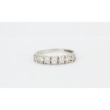 A hallmarked 9ct white gold ring set with white stones, (N).