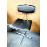 A vintage upholstered swivel desk chair.