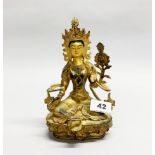 A Tibetan gilt bronze figure of a seated Tara with hand finished facial detail, H. 22cm.