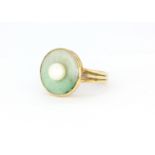 A 14ct yellow gold ring set with a natural jade disk and a cultured pearl, ring size, (N).