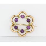 An early 20th century Murrle Bennet 9ct yellow gold Suffragette brooch set with amethyst and