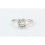 A 14ct white gold (stamped 585) ring set with brilliant and baguette cut diamonds, (O).