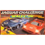 A Scalextric Jaguar challenge set with other related items and a loop chase track.
