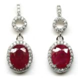 A pair of 925 silver drop earrings set with large oval cut rubies and white stones, L. 2.4cm.