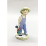 A porcelain Royal Doulton figurine of a young boy with soft toy/doll HN2040, H. 14cm.