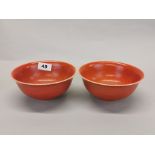 An interesting pair of Chinese orange/red glazed porcelain rice bowls, Dia. 16cm.