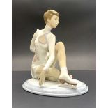A porcelain Lladro figure of an ice skater, H. 21cm.