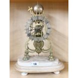 A 19th century brass skeleton clock with fusee movement mounted on a marble base, H. 40cm, W. 18cm.