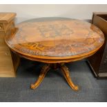 An Italian inlaid pedestal dining table with plate glass top, acid etched with the words 'For what