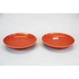 A pair of Chinese orange red glazed porcelain dishes, Dia. 22.5cm.