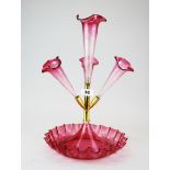 A 19th century cranberry glass and gilt metal epergne with cut glass flutes, H. with flute 40cm.