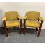 A pair of 1970's teak armchairs.