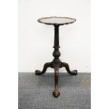 An antique carved mahogany wine table, Dia. 30cm, H. 56cm.