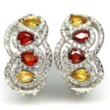 A pair of 925 silver earrings set with fancy yellow and orange sapphires and white stones, L. 1.8cm.