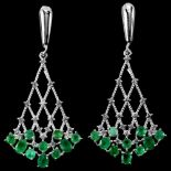 A pair of long 925 silver drop earrings set with round and oval cut emeralds and white stones, L.