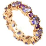 A 925 silver rose gold gilt full eternity ring set with amethysts and iolites, (O). Condition NEW,