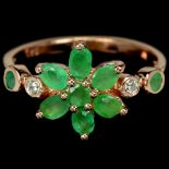 A 925 silver rose gold gilt cluster ring set with oval cut emeralds and white stones, (O). Condition