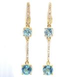 A pair of 925 silver gilt drop earrings set with blue topaz and white stones, L. 4.8cm. Condition