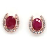 A pair of 925 silver rose gold gilt horseshoe earrings set with oval cut rubies, L. 1.3cm. Condition
