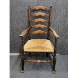 A 19th century ladder back and rush seat armchair.