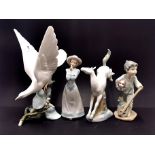 A Lladro figure of a dove, H. 27cm (tiny chip to wing), together with two Nao figures of children