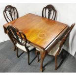 A pretty set of four carved mahogany dining chairs with a 1920's mahogany dining table.
