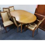 A 1970's G-plan extending oval teak dining table and six chairs, closed size 163 x 111cm.