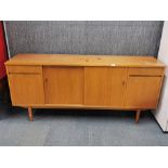 A 1970's teak sideboard, W. 181 x 46 x 83cm. Some marks to top.