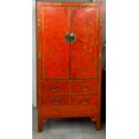 A superb Chinese lacquered and gilt two door cabinet with four drawers decorated with butterflies,