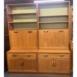A pair of 1970's teak bookcase bar cabinets, 84 x 202cm.