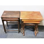 A nest of three 1970's teak tables with a nest of two oak tables.