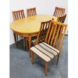 A 1970's oval extending dining table and six chairs, closed size 143 x 90cm.
