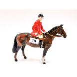 A Beswick figure of a horse and jockey.