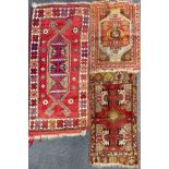 Two hand woven Persian wool rugs, 63 x 128cm. and 51 x 89cm. with a further two rugs. Provenance: