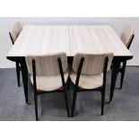 A 1960's Formica topped extending kitchen table and four chairs, closed size 121 x 81cm.