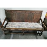 An 18th century three seater oak settle, L. 185cm.