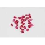 A bag of unmounted pear cut rubies, approx. 9ct.