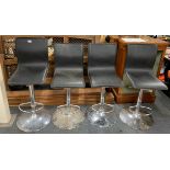 A set of four upholstered bar stools.