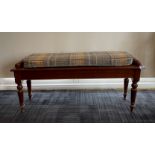 An early 20th century mahogany scroll end window seat, L. 117cm, H. 51cm, with upholstered cushion.