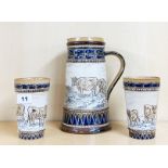 A Doulton Lambeth Hannah Barlow ale jug and two beakers with incised decoration of cattle, jug H.