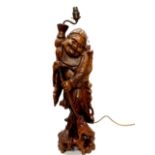 A large Chinese carved hardwood figure of a sage with Chan the three legged toad, mounted as a table