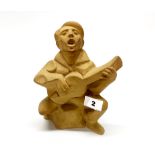 A Fulham pottery figure of a singer with a guitar modelled by Eric Griffiths, H. 23cm.