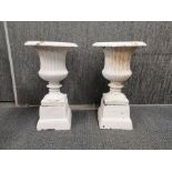 A pair of painted concrete gardens urns in two pieces, H. 50cm.