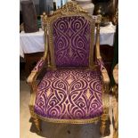 An upholstered gilt wood armchair.