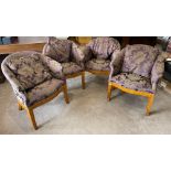 A set of four upholstered burr walnut veneered tub chairs.